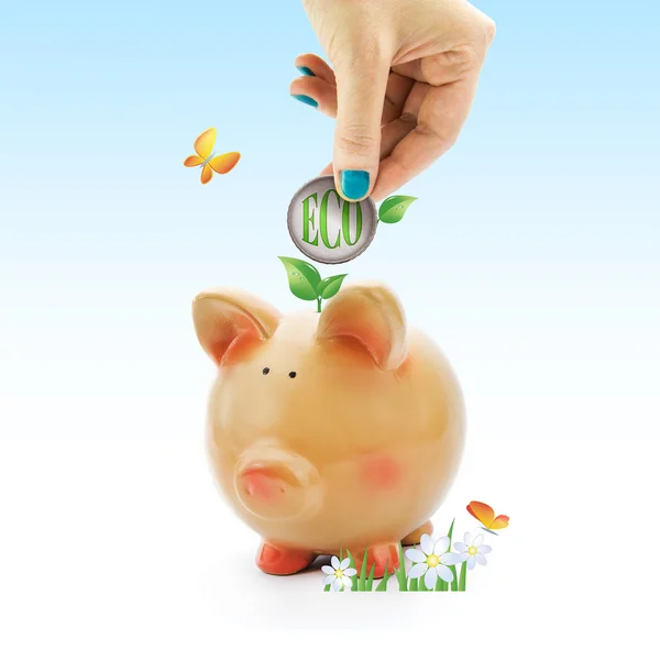 Hand storten een munt met 'eco' groene tekst en bladeren in piggy bank — Stockfoto