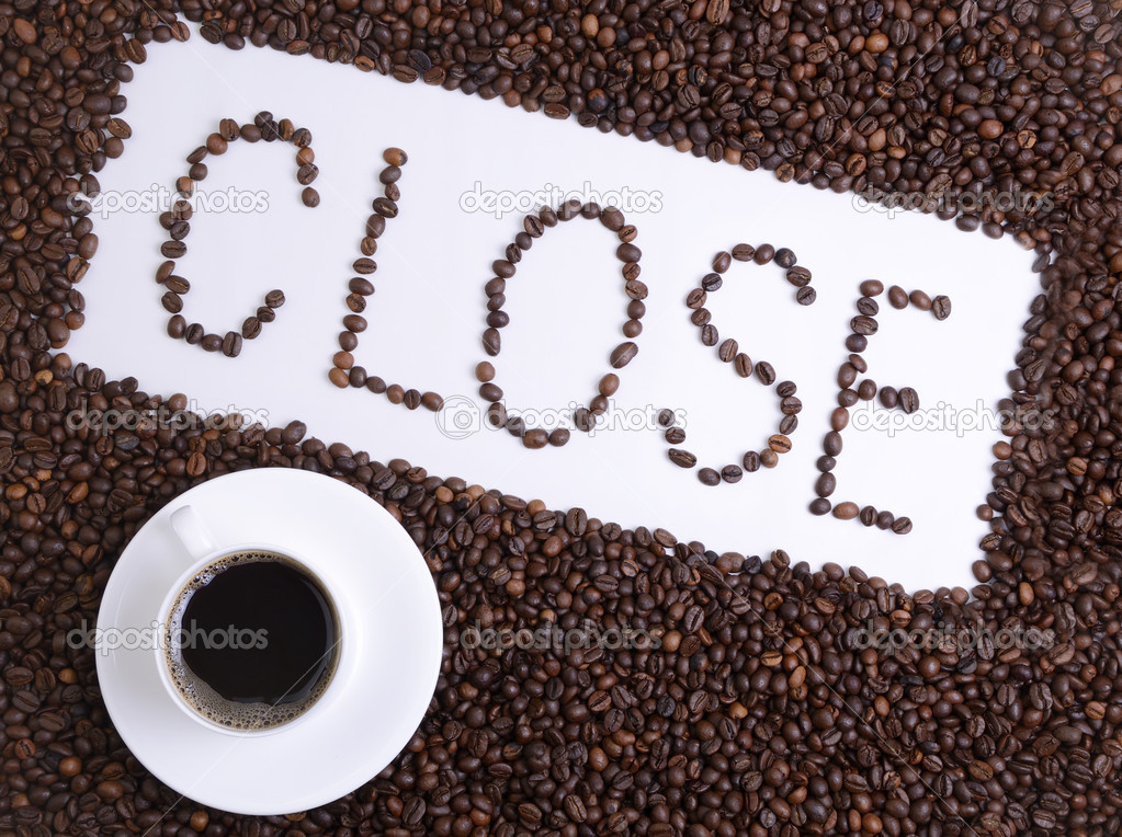 Inscription from coffee grains and a cup with coffee. Closed.