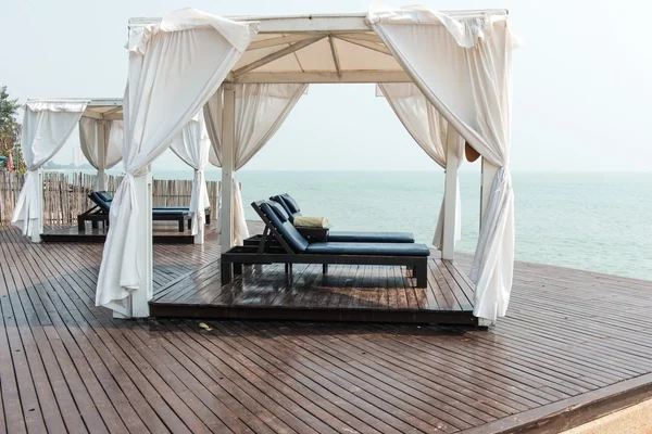 Beach front dual leather relax chairs inside a tent facing the s — Stock Photo, Image