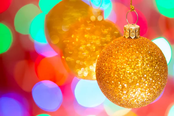Golden christmas ball on bokeh background — Stock Photo, Image