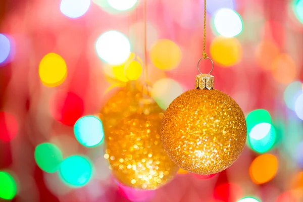 Golden christmas ball on bokeh background — Stock Photo, Image