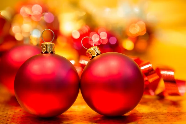 Red Christmas balls on a gold background — Stock Photo, Image