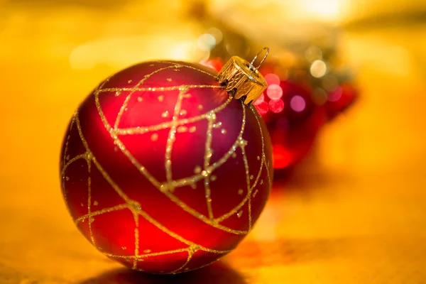 Red Christmas balls on a gold background — Stock Photo, Image