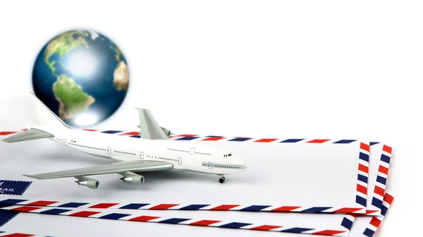 Airmail envelope with model airplane and earth (Elements of this — Stock Photo, Image