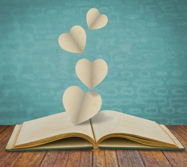 Paper cut of heart on old book clipart