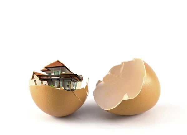 Broken egg and house is pulled out. — Stock Photo, Image