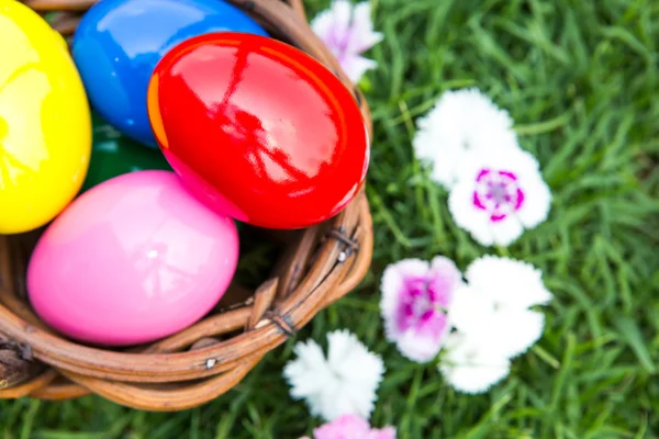 Basket of easter eggs on green grass — Stock Photo, Image