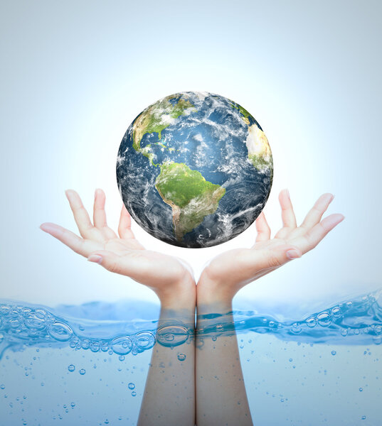 Earth in hand over water (Elements of this image furnished by NA