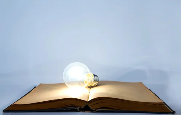 Book and light bulb — Stock Photo, Image