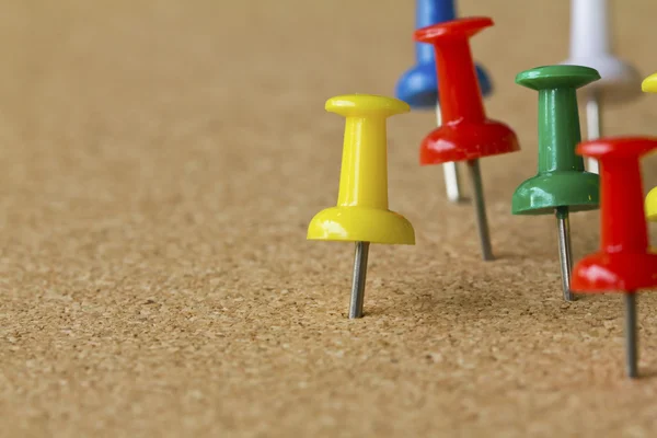 Group of colorful push pins on cork bulletin board. — Stock Photo, Image