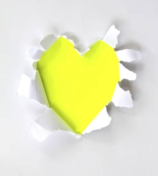 Sheet of paper with a Heart shape hole against bright yellow bac — Stock Photo, Image