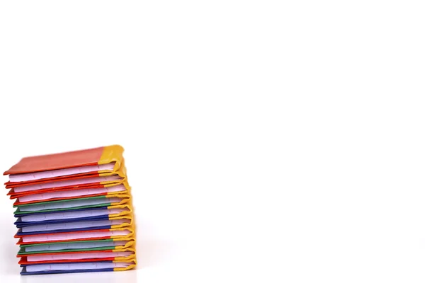 Stack of colorful books on white background, partial view. — Stock Photo, Image