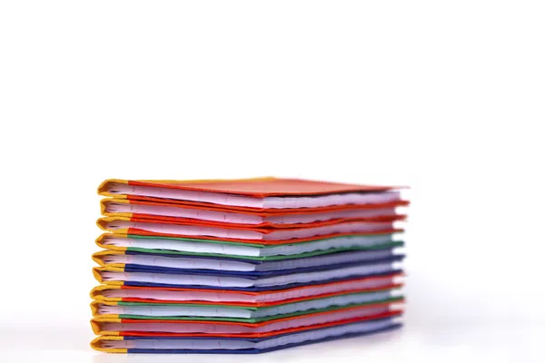 Stack of colorful books on white background, partial view. — Stock Photo, Image