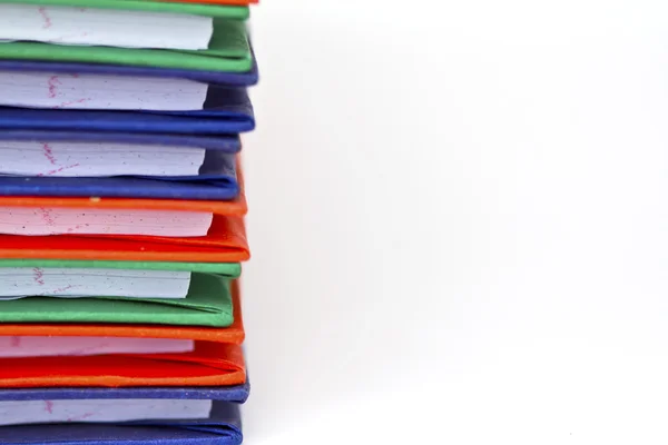 Stack of colorful books on white background, partial view. — Stock Photo, Image