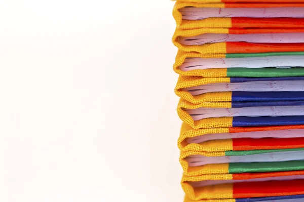 Stack of colorful books on white background, partial view. — Stock Photo, Image
