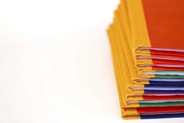 Stack of colorful books on white background, partial view. — Stock Photo, Image