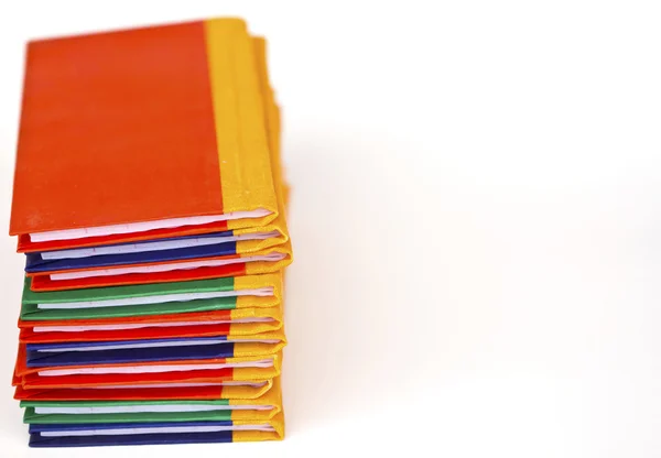 Stack of colorful books on white background, side view. — Stock Photo, Image