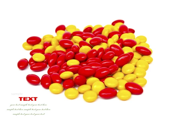Red and yellow medicinal pills on a white background with space — Stock Photo, Image