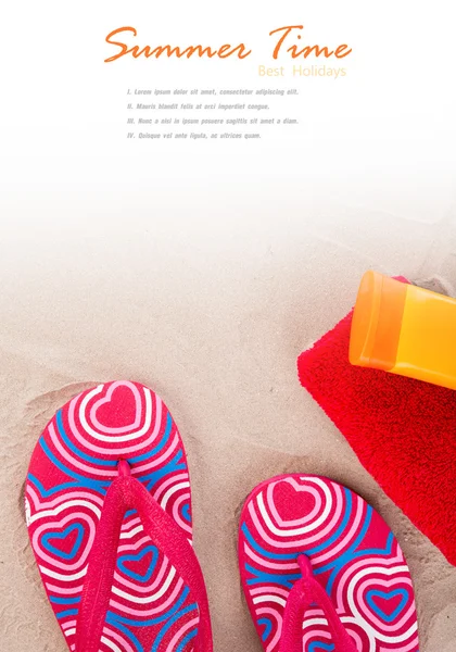 Flipflops ,sunscreen,towel on sand beach — Stock Photo, Image