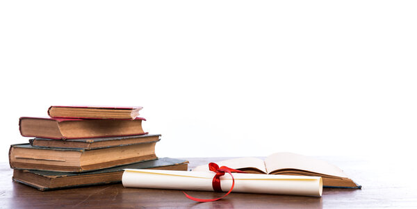 Diploma with old book isolated on a white background.