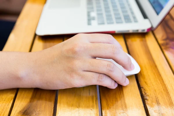 Close-up image of female hand writing on laptot — Stock Photo, Image