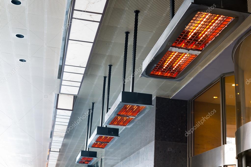 Electric heater with halogen coils at front gate of hotel Stock Photo