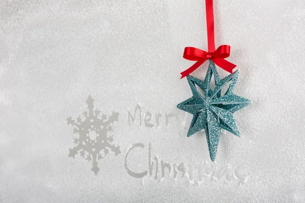 Snow on the frozen window with word " Merry Christmas " and snow — Stock Photo, Image