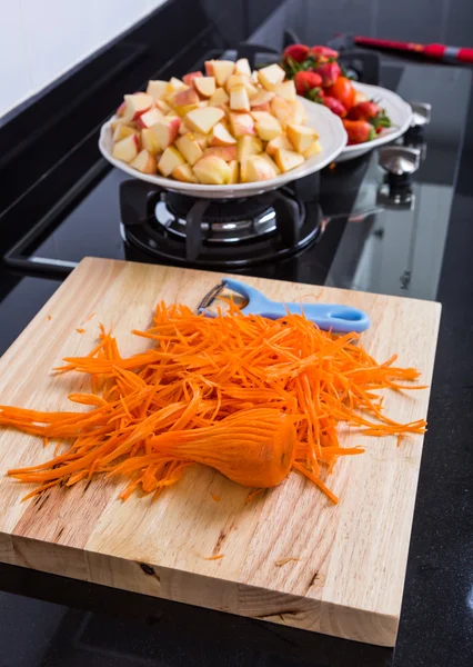 Cooking vegetables and fruit salad in kitchen — Stock Photo, Image