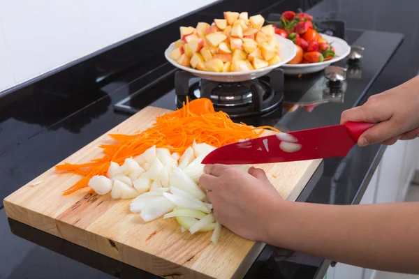 Cooking vegetables and fruit salad in kitchen — Stock Photo, Image