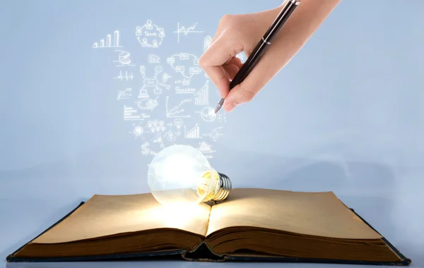 Book and light bulb with hand drawing graph — Stock Photo, Image