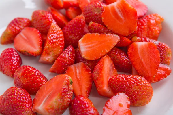 Fresh strawberries cut into pieces — Stock Photo, Image