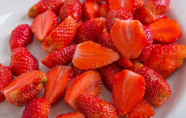 Fresh strawberries cut into pieces — Stock Photo, Image