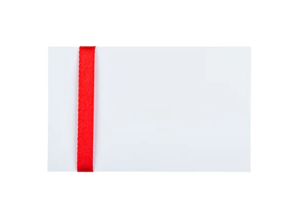 Close up of card with red ribbon bow on white background — Stock Photo, Image