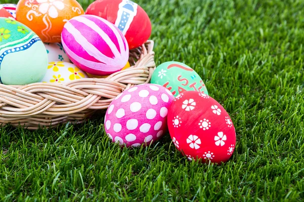 Cesta de huevos de pascua sobre hierba verde fresca — Foto de Stock