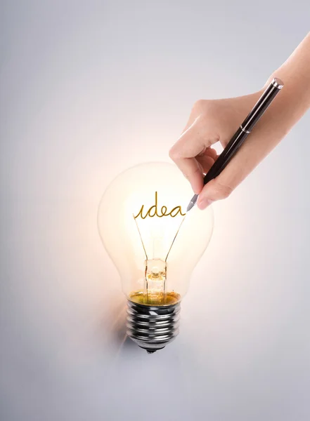 Light bulb with hand drawing idea — Stock Photo, Image