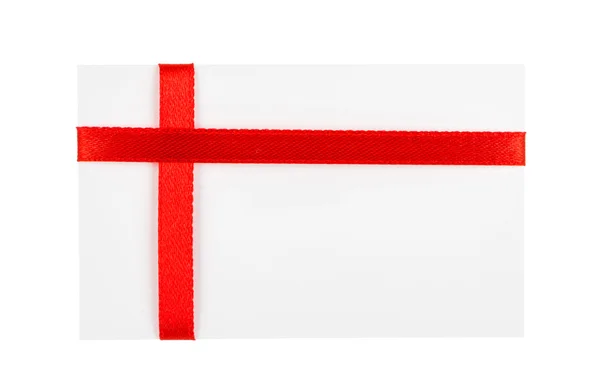 Close up of card with red ribbon bow on white background — Stock Photo, Image