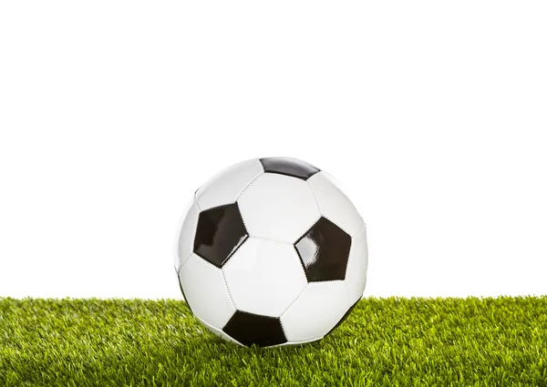 Bola de futebol na grama no fundo branco — Fotografia de Stock