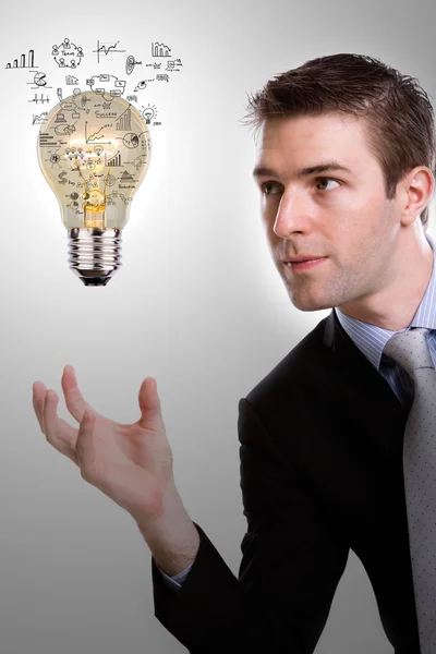 Business man holding light bulb with business concept inside — Stok Foto