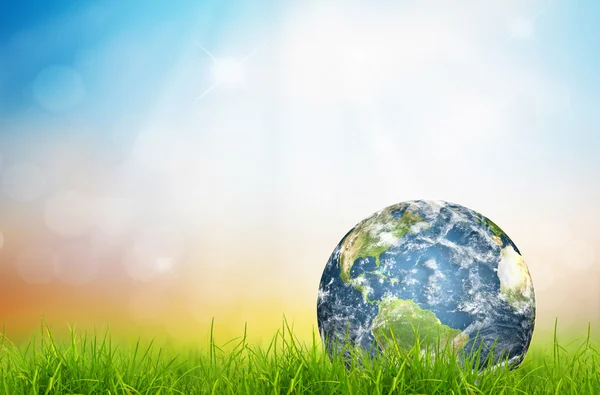 Earth in Fresh spring green grass (Elements of this image furnis — Stock Photo, Image