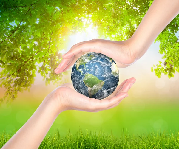 Hands with earth (Elements of this image furnished by NASA) — Stock Photo, Image