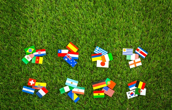 Paper cut of flags on grass for Soccer championship 2014 — Stock Photo, Image