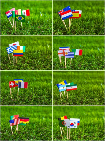 Corte de papel de bandeiras na grama para o campeonato de futebol 2014 — Fotografia de Stock