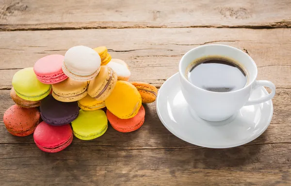 French colorful macarons with cup of coffee — Stock Photo, Image