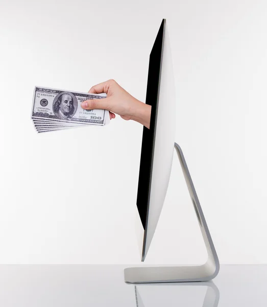 Ottenere denaro dal monitor del computer Immagine Stock