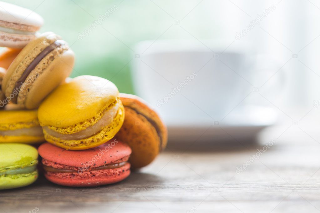 French colorful macarons with cup of coffee
