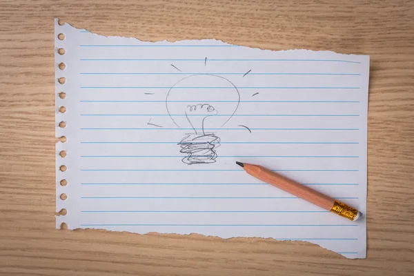 Hand dras lampa på papper med penna — Stockfoto