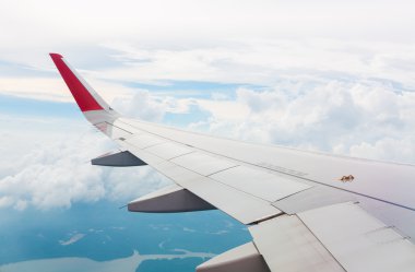 Bulutların üzerinde uçan bir uçağın kanadı