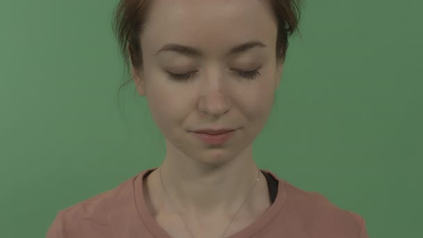 Close-up portrait of a young beautiful girl meditating with closed eyes. — Stock Video