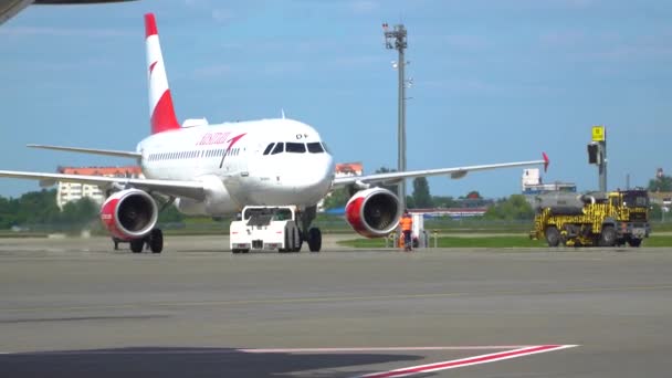 The pushback tractor is towing the aircraft to a parking lot. Aircraft is taxiing to the parking place. Kyiv, Ukraine. 20.09.2021 — Stock video