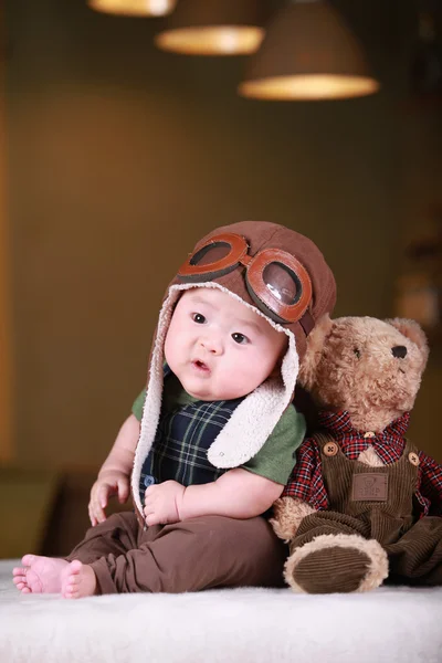 Happy cute 3-month old Asian baby boy playing on bed with colorf Stock Picture